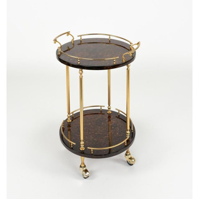 Midcentury amazing serving bar cart in brown lacquered goatskin and brass by Aldo Tura. Made in Italy in the 1960s This...