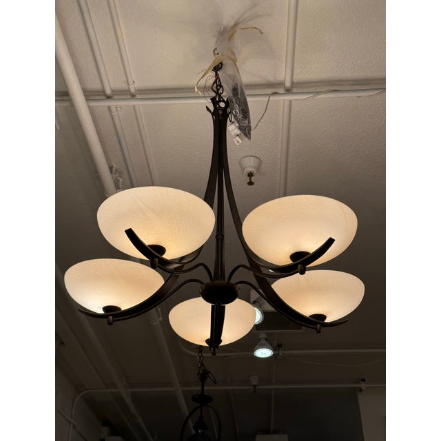 Design Plus Gallery presents an Aegis Five-Light Chandelier from Hubbardton Forge. This sculptural lighting design pairs...