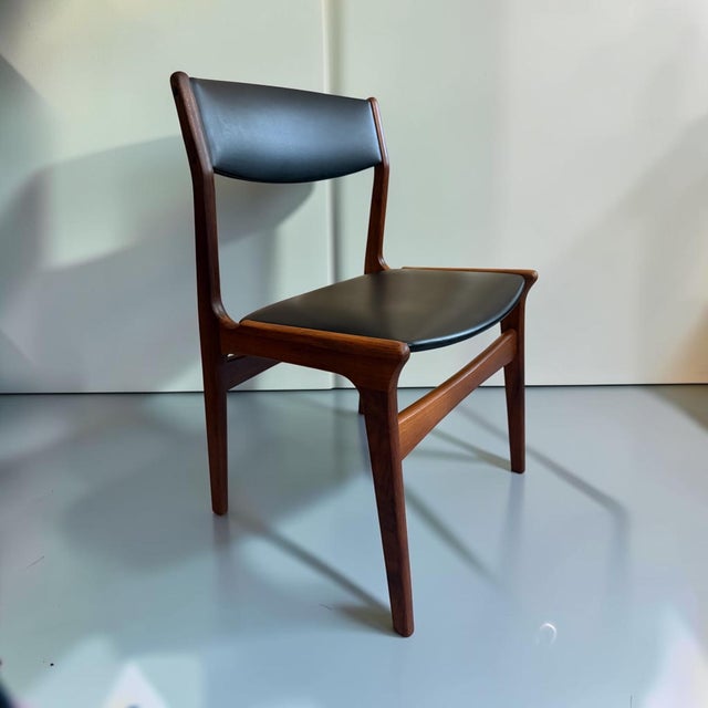 A beautiful pair of Danish Mid-Century Modern dining chairs designed by Erik Buch in the 1960s. The chairs feature elegant...