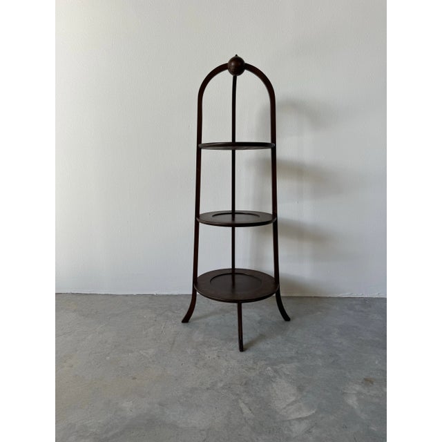 This vintage mahogany three-tier muffin or plant stand combines practicality with timeless elegance. The design features a...