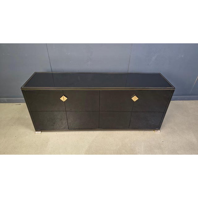 Luxurious seventies glamour sideboard by PIerre Vandel of Paris consists of black lacquer panels and brass handles and...