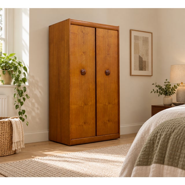 A mid-century wardrobe by EON, with attractive grain detailing. The design features two tall doors, rounded top rail and...