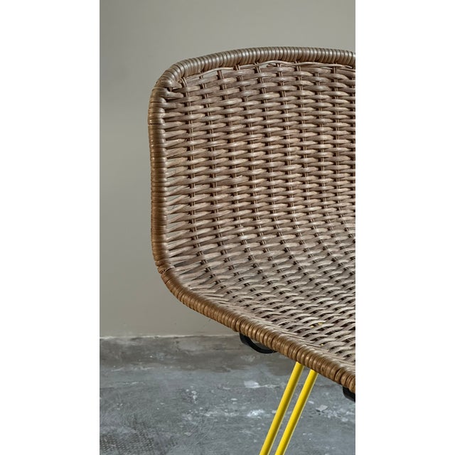 Rattan and yellow iron stool, made by Cidue, Italy, circa 1970s. The stool features a rattan seat with a wraparound shape...