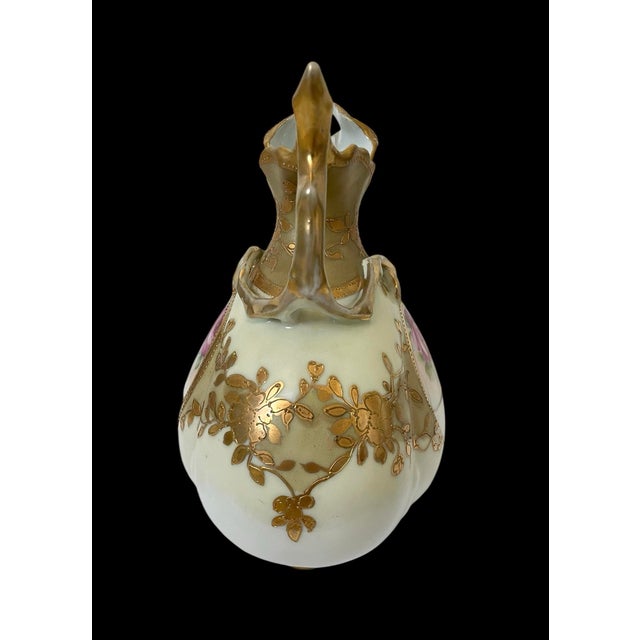 This Antique Nippon Moriage 7.5" Gold Trim Hand Painted Floral Gold Pitcher is a stunning piece of vintage porcelain from...