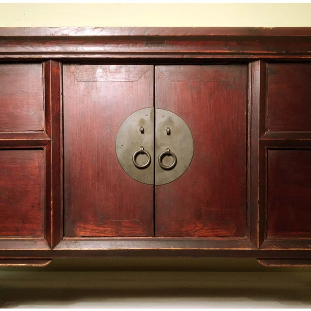 This Antique Chinese Altar Cabinet is circa early of 19th century. The spandrels and the bottom apron are uniquely carved....
