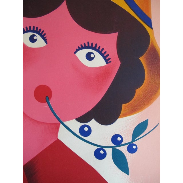 This is a colorful poster of a lady offering a bottle of Prunelle du Velay, a French spirit made of sloe. On the bottom it...