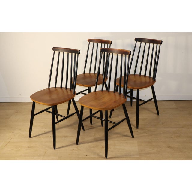 A beautiful set of four dining chairs in a vintage style dating from the 1960s. A pleasing blend of clean lines and...