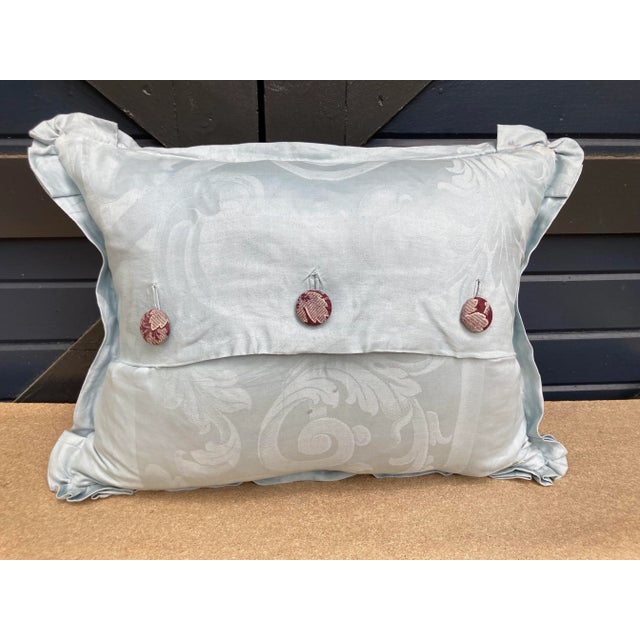 A pillow made from a circa 1880’s hand quilted French bedspread backed and edged with hand dyed linen damask. A down...