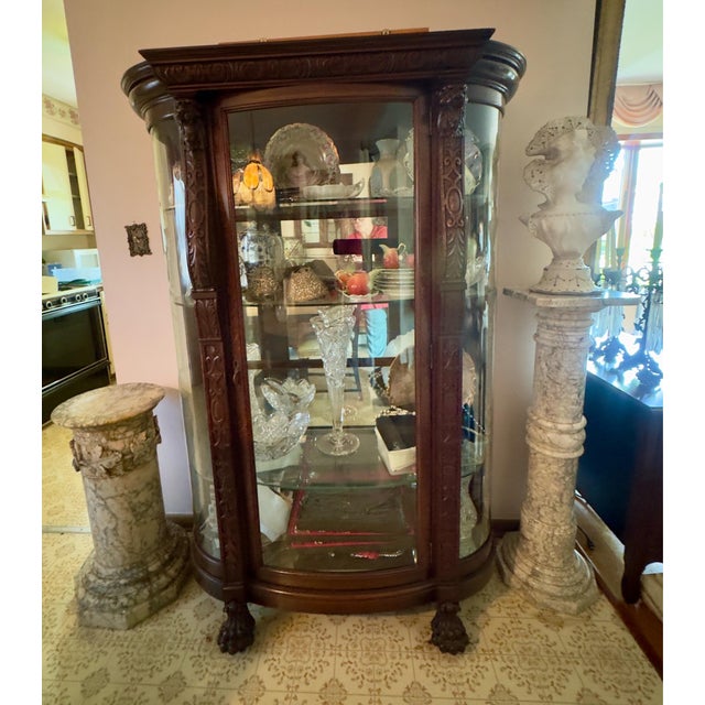 Antique Victorian Curved Glass China Cabinet. This piece features a prominent bow front glass door flanked by curved glass...