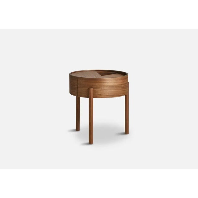 Walnut arc side table by ditte vad and julie bertrup. Materials: walnut, nano laminate. Dimensions: d 42 x w 42 x h 45 cm....