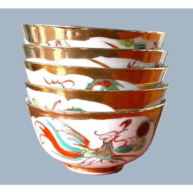 Five (5) Macau Dragon / Phoenix Rice Bowls Four gilded dragon bowls, marked mid-century. One gilded phoenix bowl, marked...