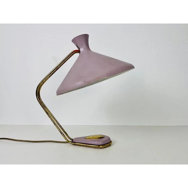 An italian table lamp made in the 1960s. The lighting has an exceptional design which is similar to the table lamps made...
