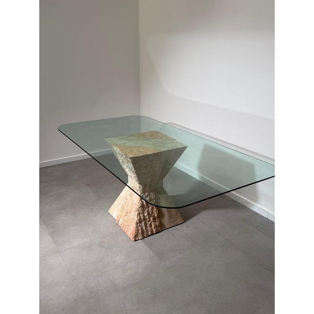 Exceptional 1970s Mactan stone dining table featuring a sculptural pedestal base crafted from hand-worked Mactan stone and...