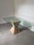 Exceptional 1970s Mactan stone dining table featuring a sculptural pedestal base crafted from hand-worked Mactan stone and...