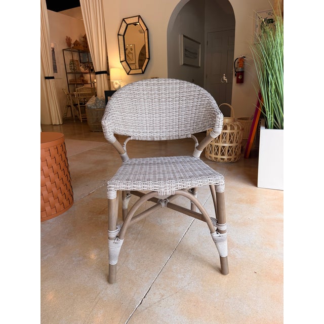 This woven resin wicker dining chair blends coastal, transitional, and organic-modern style with natural materials and...