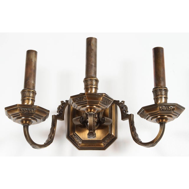 Pair of traditional cast brass triple arm wall sconces with newly brass candle covers
