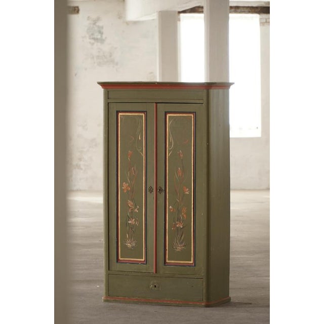 A charming and rare antique Dansih "Almue" cabinet, beautifully decorated in the tradition of Scandinavian folk art. The...