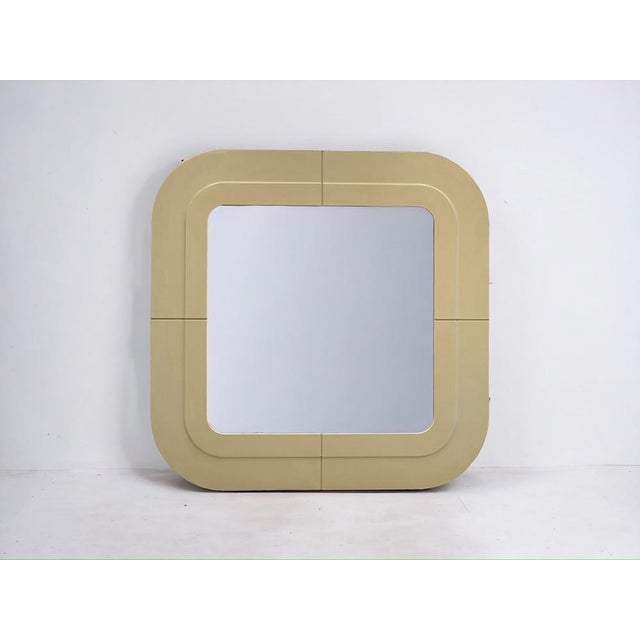 Vintage Kartell wall mirror with softly rounded square frame in beige ABS plastic. Made in Italy in the 1960s and...
