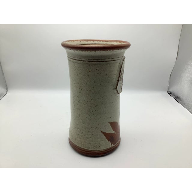 A lovely mid-century themed vase with two mugs. The vase is signed on the base, but I can not make out what the signature...