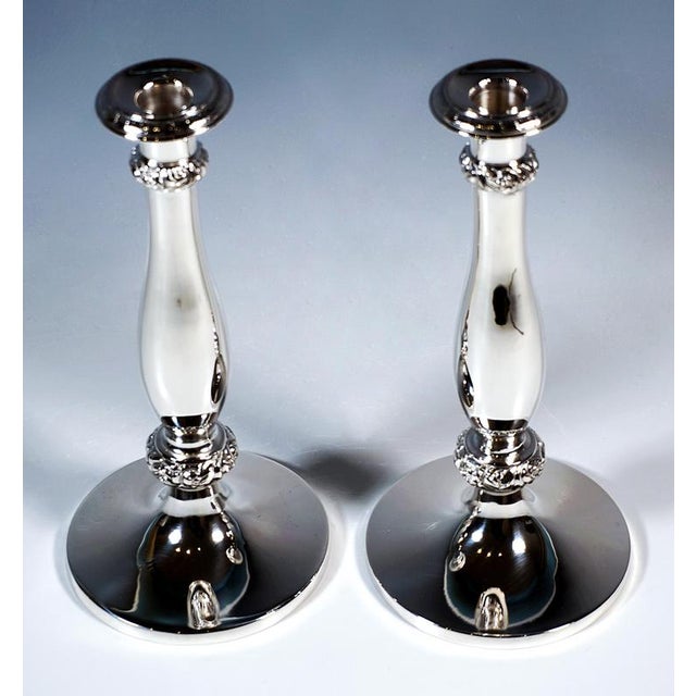 Two festive biedermeier silver candlesticks on a round, smooth raised base with a smooth, baluster-shaped shaft, with...