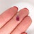 A ruby glows with red brilliance at the heart of this emerald cut pendant. Hand-set in solid 14K white gold, it balances...