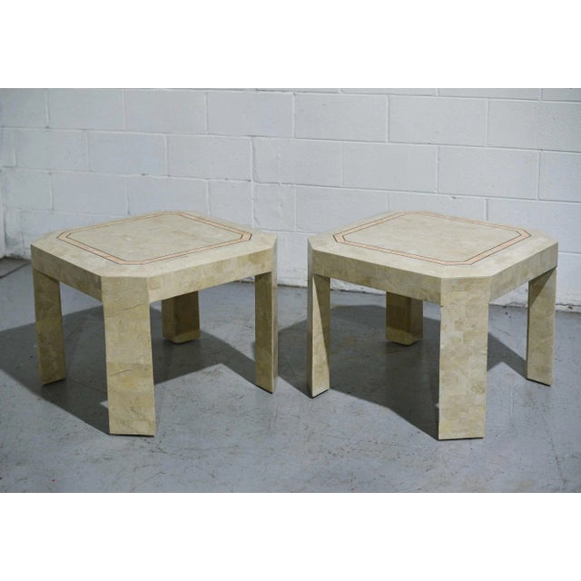 Beautiful pair of Maitland-Smith Style tessellate stone side tables with pink and gold inlay and beveled edge. In...
