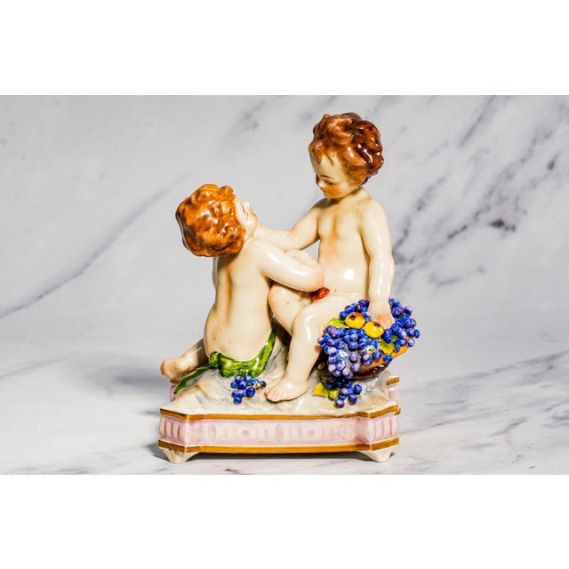 A delightful pair of circa 1900 Capodimonte polychrome porcelain figures, these charming sculptures embody the playful...