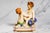 A delightful pair of circa 1900 Capodimonte polychrome porcelain figures, these charming sculptures embody the playful...