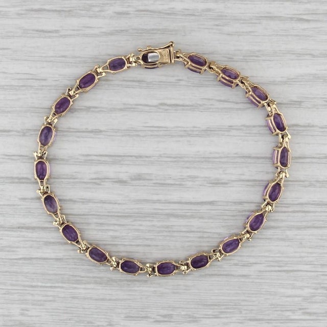 Gemstone Information: - Natural Amethysts - Total Carats - 8.70ctw Cut - Oval Color - Purple Metal: 18k Yellow Gold...