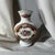 The maker mark on the bottom of the vase reveals that it is a vintage porcelain piece produced by the Italian design firm...