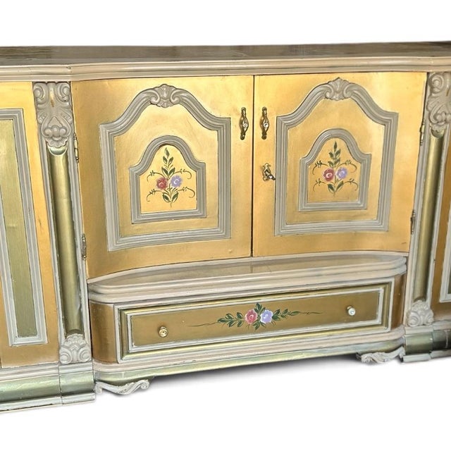 A spectacular vintage Rococo Revival display cabinet featuring an elaborate architectural silhouette, curved glass side...
