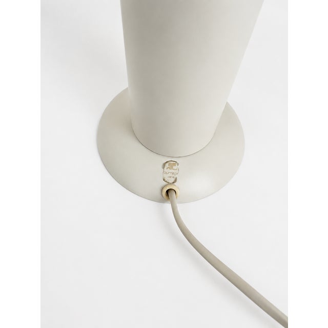 Removable lampshade held in place by two knobs, mounted on a white lacquered metal base. I have official proof of...