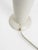 Removable lampshade held in place by two knobs, mounted on a white lacquered metal base. I have official proof of...