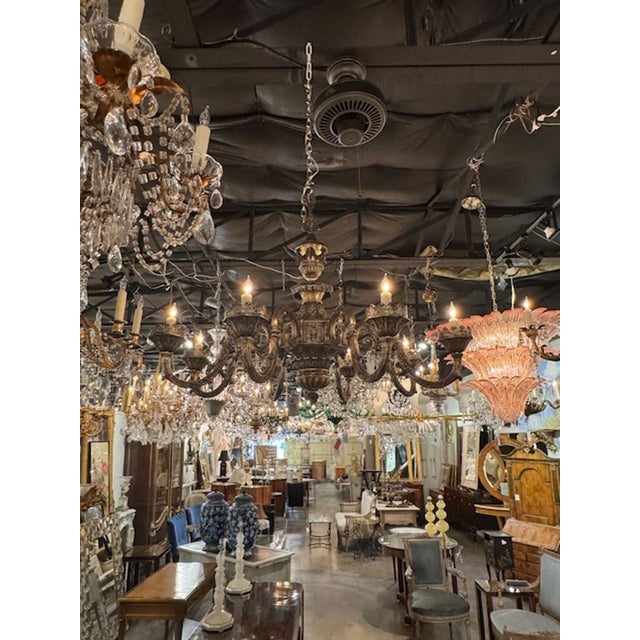 The Antique Silver Over Bronze Chandelier by Caldwell is a stunning piece of lighting that adds a touch of elegance to any...