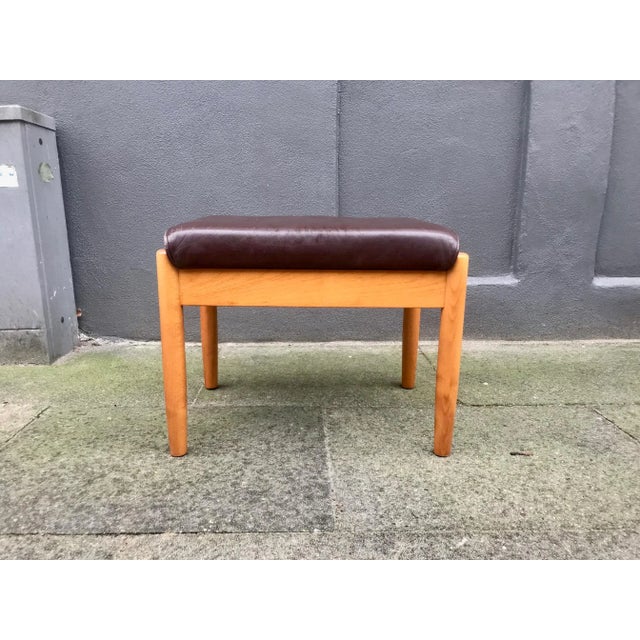 Practical ottoman in brown leather and solid beech. It features a hidden storage room with enough room for a laptop,...