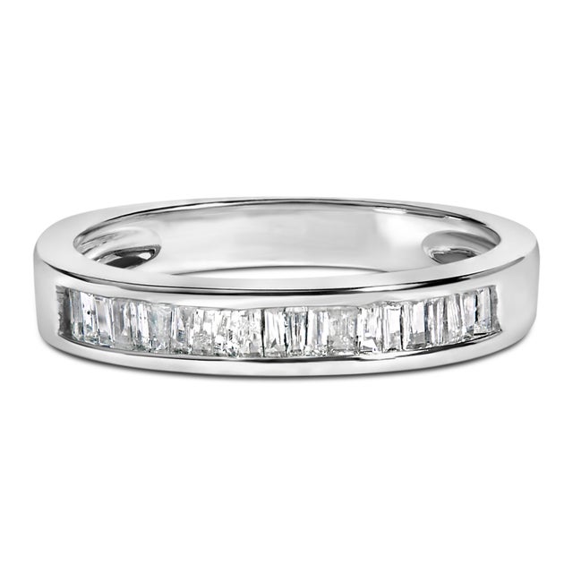 Elegant and timeless, this rhodium-plated .925 sterling silver diamond band features 0.31 carat total weight of baguette...