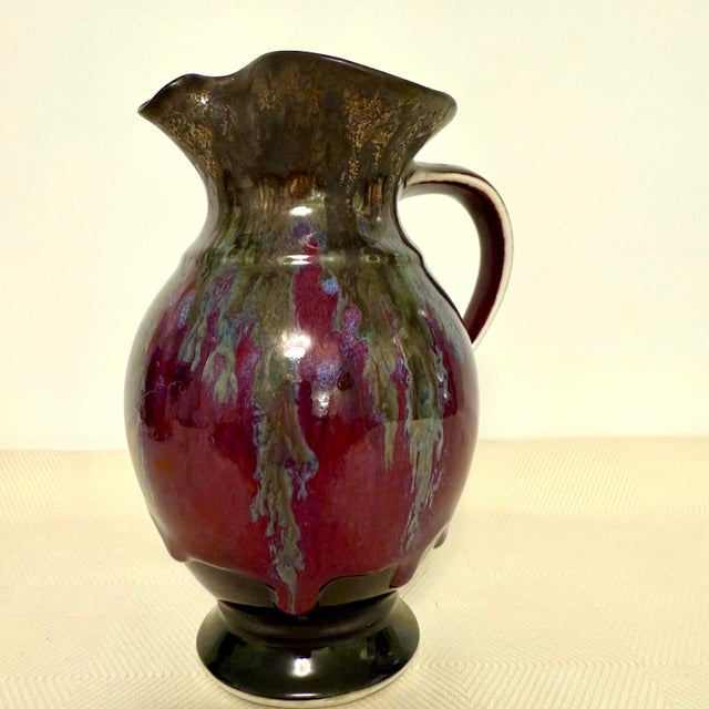 This handcrafted stoneware pitcher by Edgecombe Potters features a bold molten drip glaze with strong movement and...
