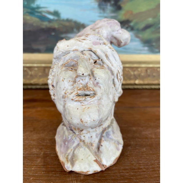 A hand-built studio ceramic sculpture depicting a whimsical male bust, likely created in the mid-20th century. This...