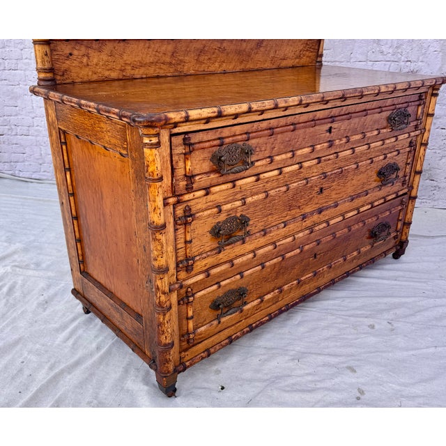 19th century RJ Horner faux bamboo birdseye maple dresser and mirror. Dresser features unique craftsmanship with three...