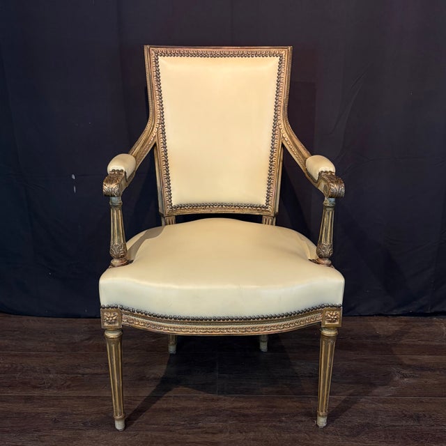 Elegant set of four antique French Louis XVI fauteuil armchairs featuring beautifully carved giltwood frames and refined...