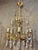 Beautiful neoclassical Empire chandelier crafted in brass with richly cut prism crystals. The lamp features 6 elegant arms...
