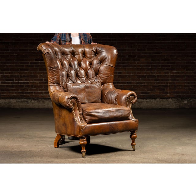 Traditional vintage wingback armchair. This piece features plush button tufts and a comfortable seat cushion. Years of use...