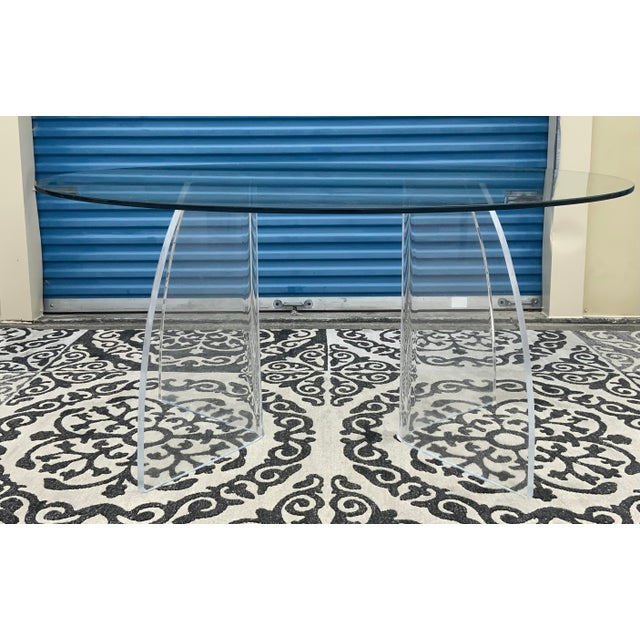 Gorgeous Lucite and glass dining table. Makes for an elegant space in any home. Comes with the glass top and two Lucite...