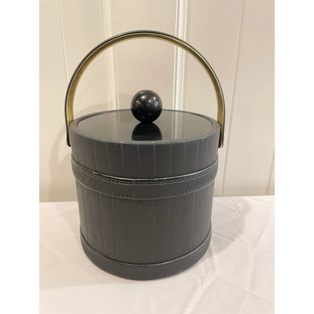 Gorgeous, black leather pinstripe ice bucket. Brass accents including interior of handle.