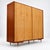Vintage 4-door wardrobe / linen cabinet from the 1960s or 70s. This spacious vintage wardrobe combines a light wood grain...