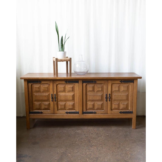 A commanding Danish oak sideboard by Henning Kjærnulf, produced in the 1970s and measuring just over 78 inches wide — a...