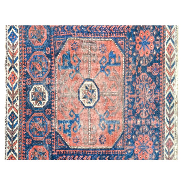 A beautiful early 20th century Persian Baluch rug with a fantastic tribal pattern containing multiple stylized flowers...