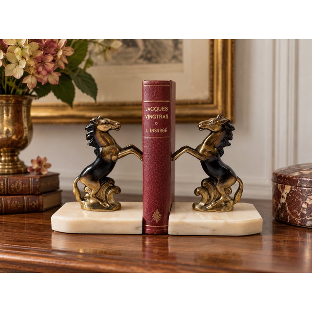An elegant pair of French Art Deco bookends featuring two spirited rearing horses, signed TEDD, circa 1930s. The finely...