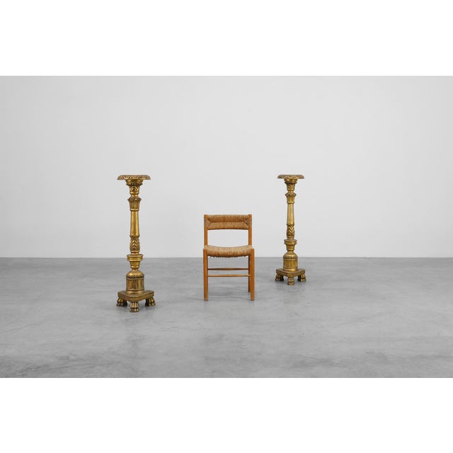 A refined example of 19th‑century French decorative craftsmanship, this pair of gilt wooden pedestals combine the...