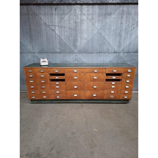 Striking mid-century haberdashery counter with 42 drawers in different sizes. Each drawer features its original card...